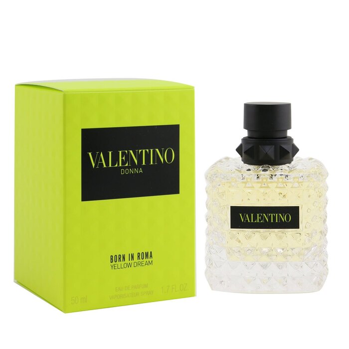 Valentino Born In Roma Yellow Dream Eau De Parfum Spray 3.4 oz presented by Paris Connection Perfumes, featuring a striking bottle with a bright yellow hue and elegant geometric design, encased in a vibrant yellow box adorned with Valentino's signature motifs