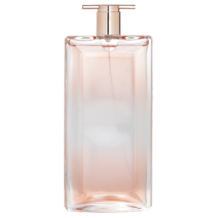 IDOLE AURA 3.4 OZ EDP from Paris Connection Perfumes features an elegant and modern bottle design, shaped like a luminous crystal that reflects light beautifully. The luxurious packaging showcases a soft pastel color palette, creating a visually stunning presentation that enhances the allure of this captivating fragrance.