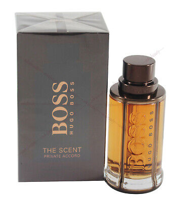 A 3.3 oz bottle of BOSS The Scent EDT for Men by Paris Connection Perfumes, featuring a sophisticated design with a dark amber hue, offering a warm and seductive fragrance.