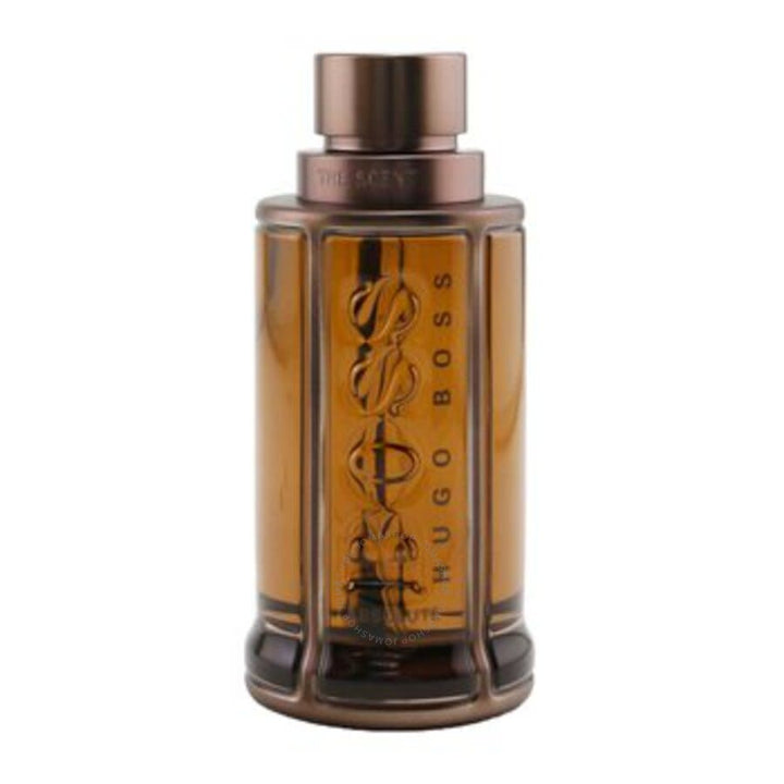 A 3.3 oz bottle of BOSS The Scent Absolute by Paris Connection Perfumes, showcasing a sophisticated design with a rich amber color, delivering a warm and alluring fragrance for men.