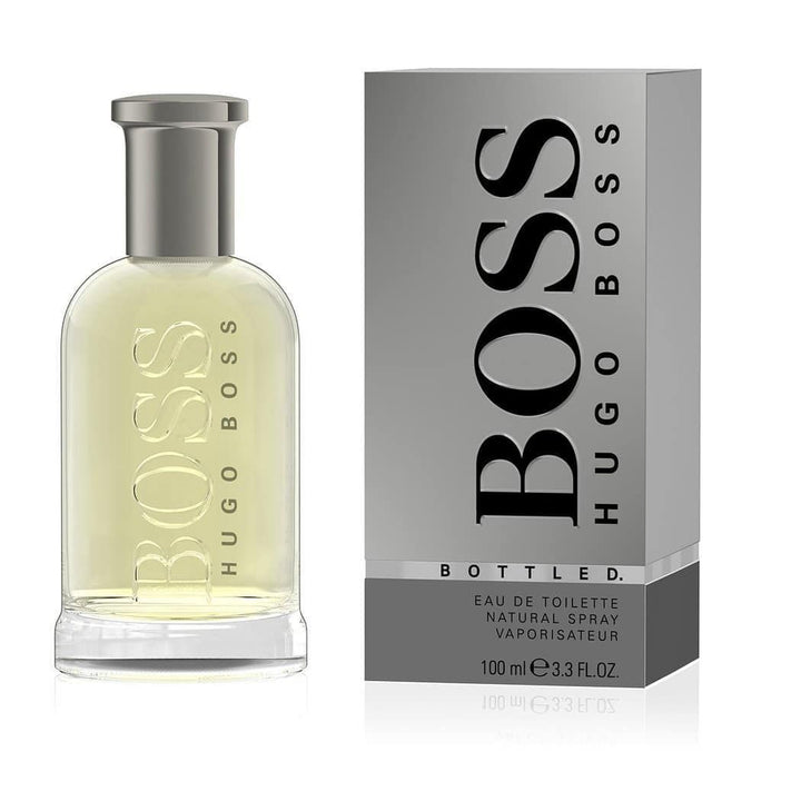 HUGO BOSS BOTTLED EDP 3.3 OZ displayed elegantly at Paris Connection Perfumes, featuring a sleek, modern bottle with a classic design. The transparent glass showcases the rich amber liquid inside, complemented by a stylish black cap, all presented in a sophisticated box with a minimalist aesthetic