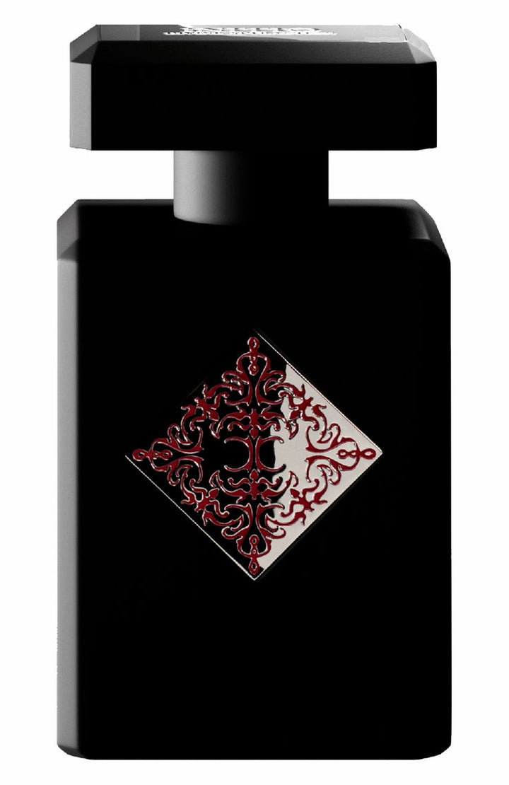 INITIO BLESSED BARAKA 3.04 OZ from Paris Connection Perfumes features an elegant, minimalist bottle with a sleek black finish, showcasing its luxurious design. The fragrance is packaged in a sophisticated box adorned with intricate gold accents, reflecting the opulence and allure of the scent within.