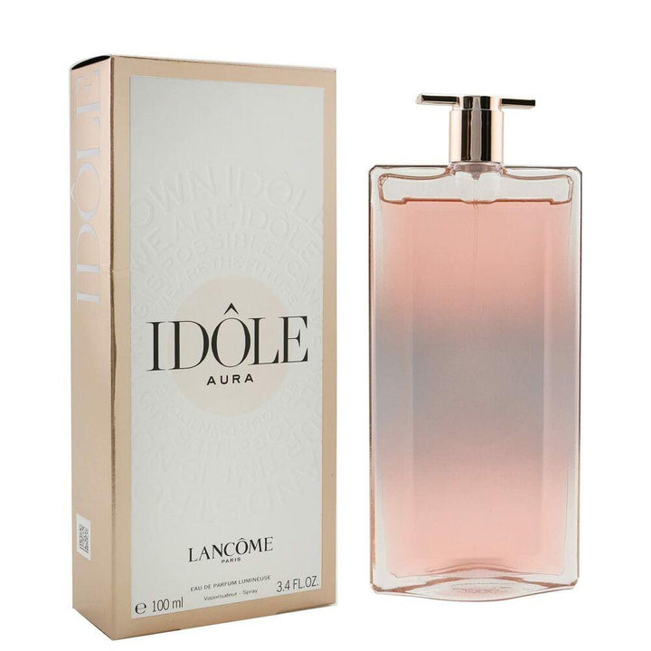 The IDOLE AURA 3.4 OZ EDP, available at Paris Connection Perfumes, boasts a chic, architectural bottle that resembles a radiant gemstone, embodying the essence of sophistication. Its sleek packaging is adorned with delicate details, making it a perfect gift for any fragrance lover.