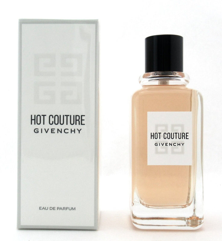 HOT COUTURE 3.3 OZ EDP by Paris Connection Perfumes features a strikingly elegant bottle with a deep red hue and a gold cap, exuding luxury. The packaging showcases a modern design, reflecting the boldness of the fragrance within.