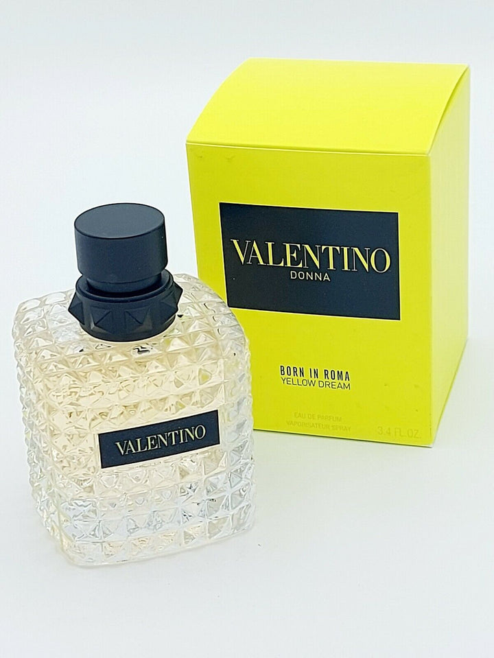 Explore Valentino Born In Roma Yellow Dream Eau De Parfum Spray 3.4 oz at Paris Connection Perfumes, showcasing a luxurious bottle that exudes modern elegance with its bold yellow color and faceted texture, beautifully packaged in a matching yellow box that reflects its radiant scent.