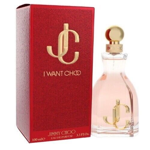 I WANT CHOO 3.3 OZ EDP by Paris Connection Perfumes features an elegant, heart-shaped bottle with a gold cap, elegantly displayed in a luxurious red and gold box that exudes glamour."